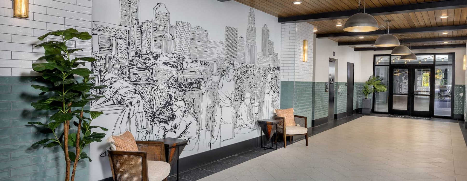 a hallway with wall art, a plant and chairs